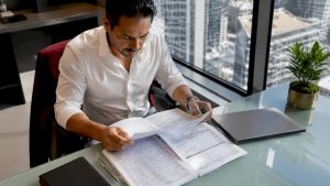 Businessman reviewing tax documents at desk