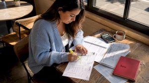 Woman organizing tax documents at home desk