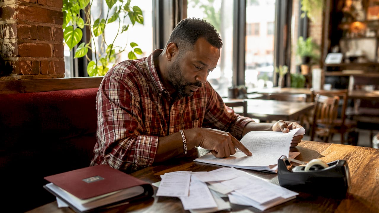 Restaurant owner reviewing cash deposits
