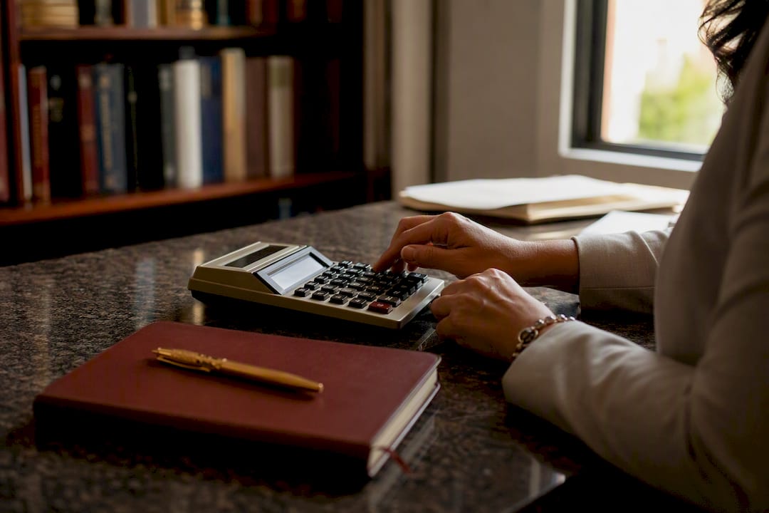 Hands calculating payroll figures