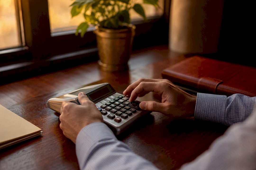 Hands calculating tax penalties on calculator