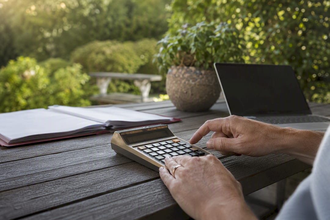 Hands calculating endowment investments